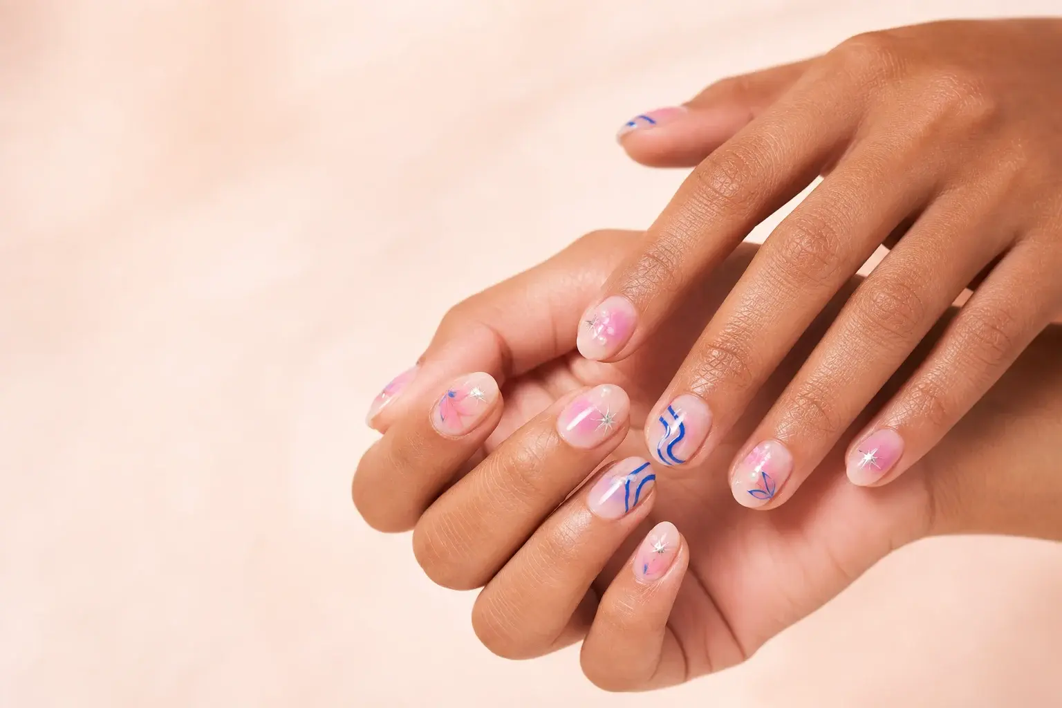 Two hands wearing a coordinated ReadyGlow custom nail set